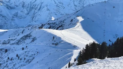 Wide view of a snowy ski slope in Megeve, located in the French Alps, Haute Stock Footage 346709408