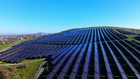 Wide view of solar panel installation on green hill Stock-Footage 334318177