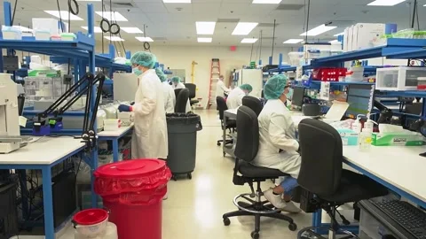 Wide view of staff working in a crime laboratory testing DNA samples Stock Footage 345299194