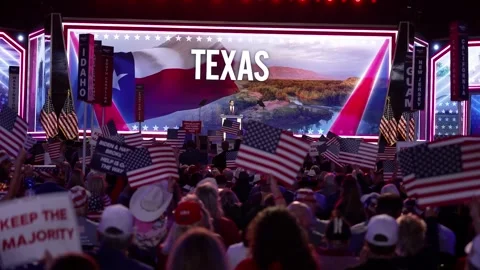 Wide view of the stage with a 'Texas' backdrop as delegates wave flags Stock Footage 345271510