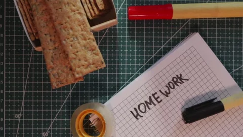 Wide view of study break with Homework notebook and crispbread Stock Footage 341269473