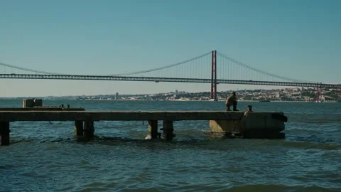 Wide view of Tagus river. Massive red Ponte 25 de Abril bridge, Lisbon Portugal. Stock Footage 273793900