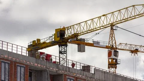 Wide view of tower cranes working on residential building construction Stock Photos