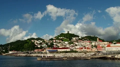 Wide view of town and white clouds over hill of St George’s Stock Footage 75680604