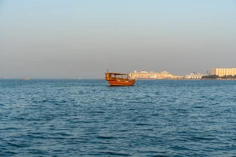 Wide view of traditional Qatari dhow with Mina District in the background. Stock Photos