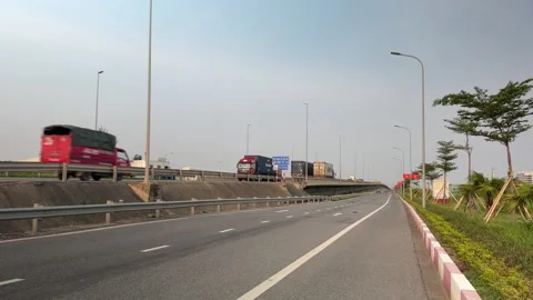 Wide view of trucks on bridge approach to Lach Huyen Port . Stock-Footage 342579903