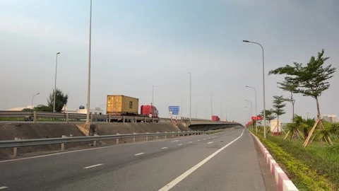 Wide view of trucks driving toward Lach Huyen Port bridge. Stock-Footage 342579904