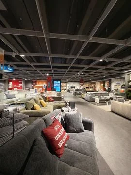 Wide view of various modern sofas on display in a large store. Stock Photos