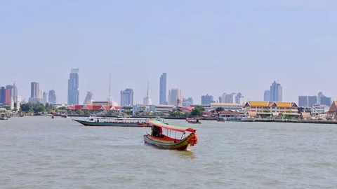 Wide view Wat Arun temple complex with riverfront and colorful flags Bangkok Stock Footage 331205234