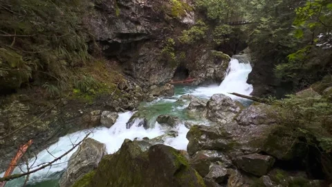 Wide view waterfall cascading down multiple levels of rocks Stock Footage 239074866
