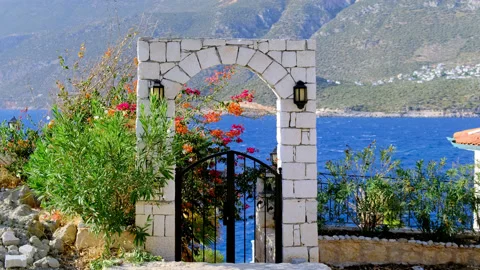 Wide view on white stone arch at entrance to house, which stands on sea or ocean Stock Footage 164798320