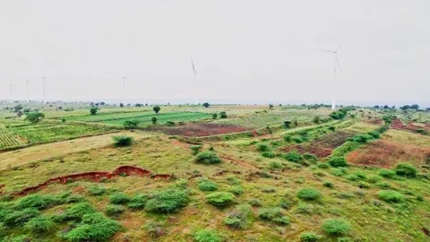 Wide view of Wind mills with farming land, haze and sky at utnal, karnataka Stock Footage 345277149
