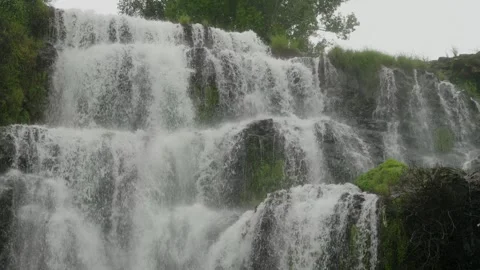 Wide waterfall cascades falling down from the cliffs. 库存影片 329557448