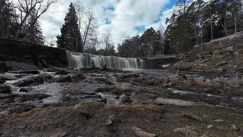 Wide waterfall flowing through a rocky river landscape, static shot Stock Footage 337554583