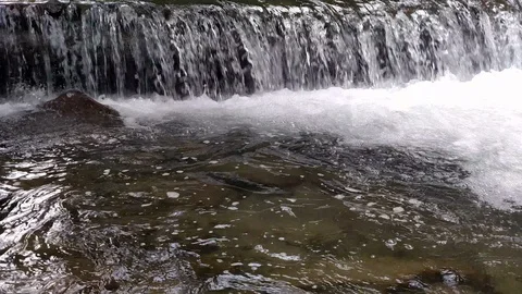 Wide waterfall on a mountain river in dark summer day Foamed water Falling Stock Footage 116719448