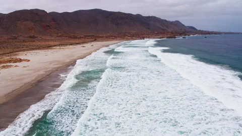 Wide Waves Roll Onto an Isolated Desert Beach, Chile Stock Footage 345537478