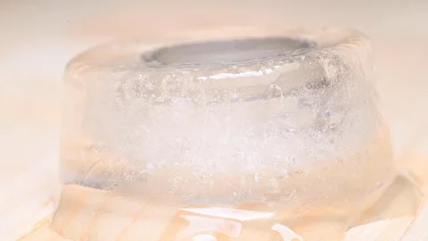 Wide wedding ring on a block of ice smelting. Time-lapse video. Stock Footage 115444976