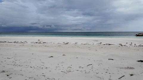 Wide White Sand Beach with Dark Stormy Sky Over Ocean Stock Footage 268708554