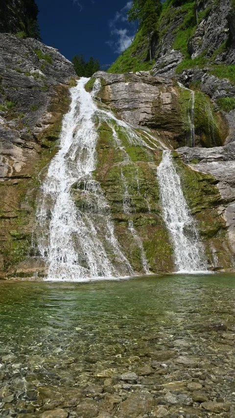 Wideangle vertical shot of a waterfall in the mountains Stock-Footage 260875254