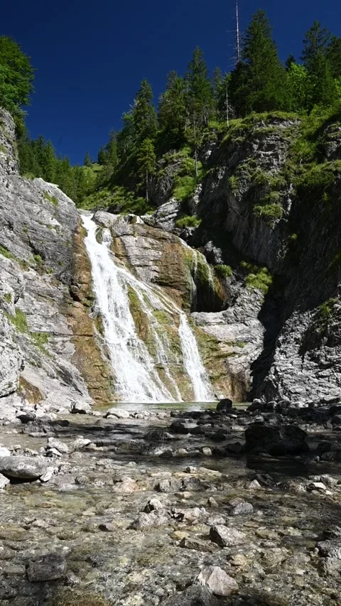 Wideangle vertical shot of a waterfall in summer, slow motion Stock-Footage 260878299