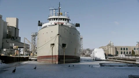 Wider Pan Righted of Ship moored in Dock in Frozen Lake Stock Footage 89945023
