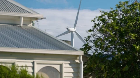 Wider shot of wind turbine in close proximity to house. Stock Footage 87646846