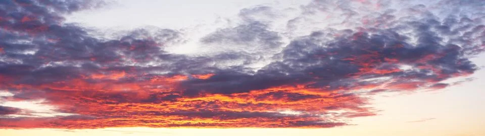 Widescreen panorama of the sky with clouds at sunset Stock Photos