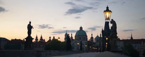 Widescreen shot of the stautes of St. Charles Bridge in Prague at sunrise Видео 284495526