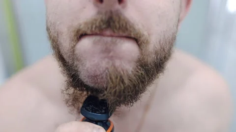 Widespread problem of dry or irritated skin after beard shaving, man removing Stockbeeldmateriaal 220831497