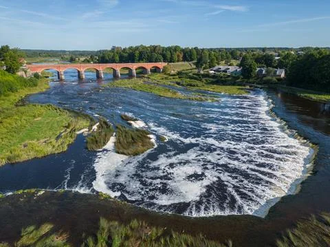 Widest Latvia river waterfall cascade and red bridge in Saldus city Stock Photos