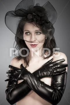 Widow. classy lady in elegant haute couture ensemble with a fascinator hat. Stock Photos