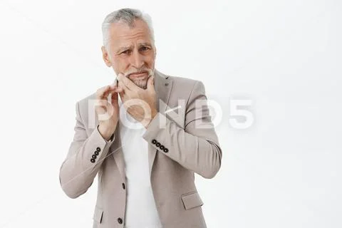 Wife bothering old man to shave. Portrait of unhappy and gloomy senior male Stock Photos