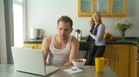 Wife kissing husband goodbye Stock Footage