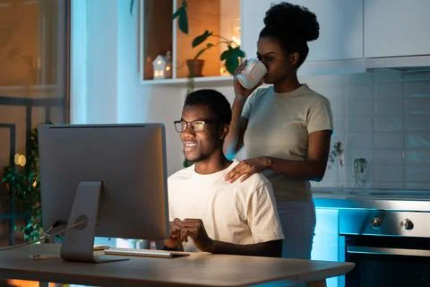Wife support husband web programmer in creating app or website design for Stock Photos