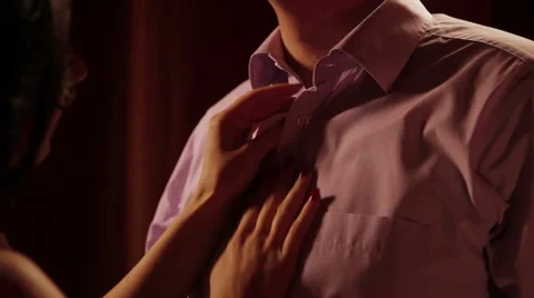 Wife unbuttoning shirt husband Stock Footage 59791579