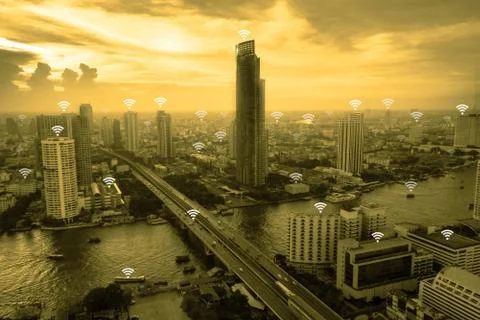 Wifi network connection concept above cityscape background with yellow tone. Stock Photos