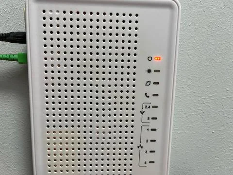 Wifi router with network cable on the wall in the room. Stock Photos
