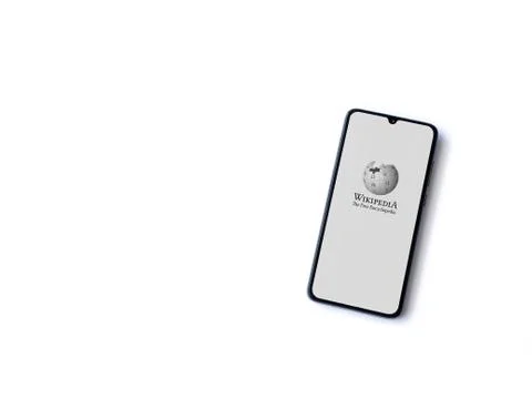 Wikipedia app launch screen with logo on the display of a black mobile smartp Stock Photos