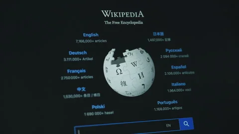 Wikipedia logo on a computer screen in dark mode 動画素材 333537124