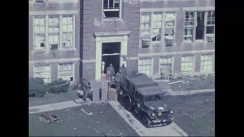 WILBERFORCE, OHIO - 1974: Tornado disaster — Troops clear a damaged building 库存影片 342609715
