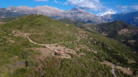Wild Alpine Landscape With Cloud Covered Peaks and Remote Forest Structure Stock Footage 326935103