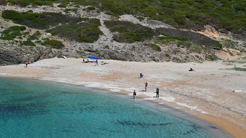 Wild beach in the Mediterranean secluded with tourists in Sardinia Stock Footage 106726853