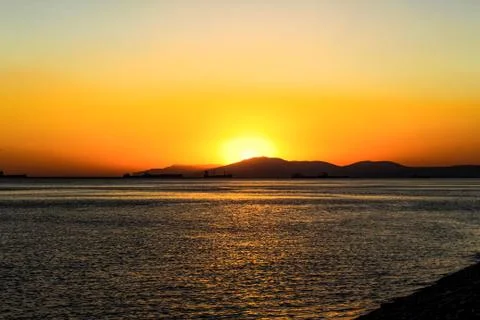 Wild beach with a sunset view on the background of the city of Novorossiysk 스톡 사진