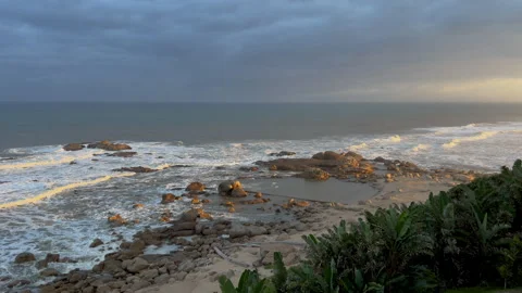 Wild beach with waves breaking on rocks, North Coast, Kwazulu Natal South Africa 動画素材 243358492