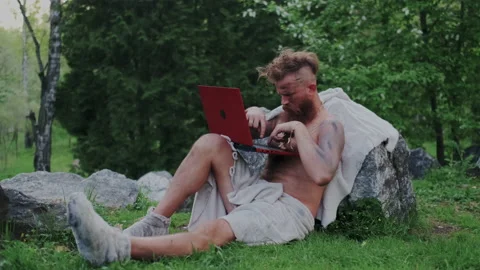 Wild Bearded, Ancient Ancestor Using Using Cloud Internet Technology on Laptop Stock Footage 131292050