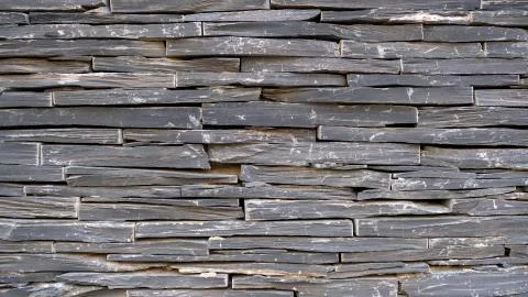 Wild brawn decorative stone background, Fragment of a textured stone wall. Stock Photos