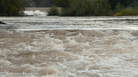 Wild flooded river flowing rapidly downstream Stock Footage 139944344