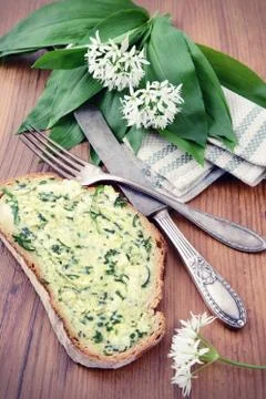 Wild garlic on table with silverware and slice bread with butter Stock Photos