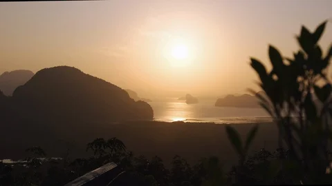 Wild grass shrub sways in the wind against the backdrop of mountains, ocean Stock Footage 128288221