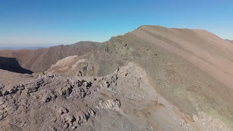 Wild ibex herd on remote alpine ridge in clear sky Stock Footage 335760027